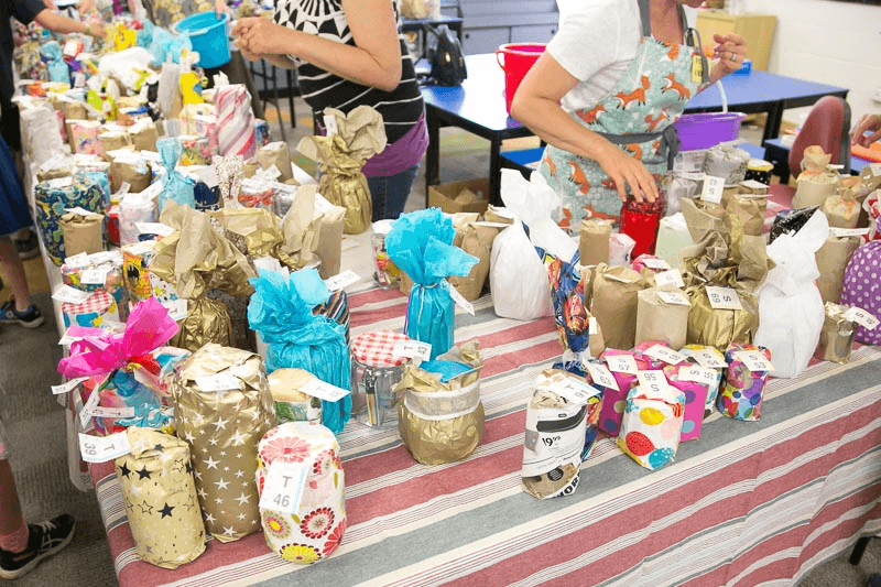Pick-a-jar stall display with wrapped jars and numbered prizes